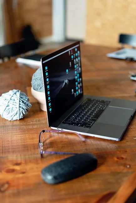 A modern workspace featuring dual computer monitors displaying web design projects, emphasizing technology and productivity.